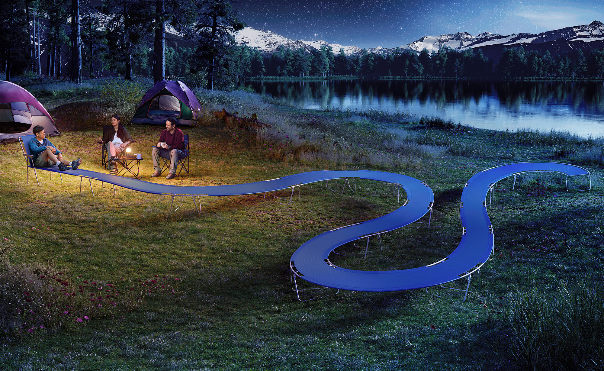 An adolescent laying in an extended camping chair among friends in the wilderness during the night