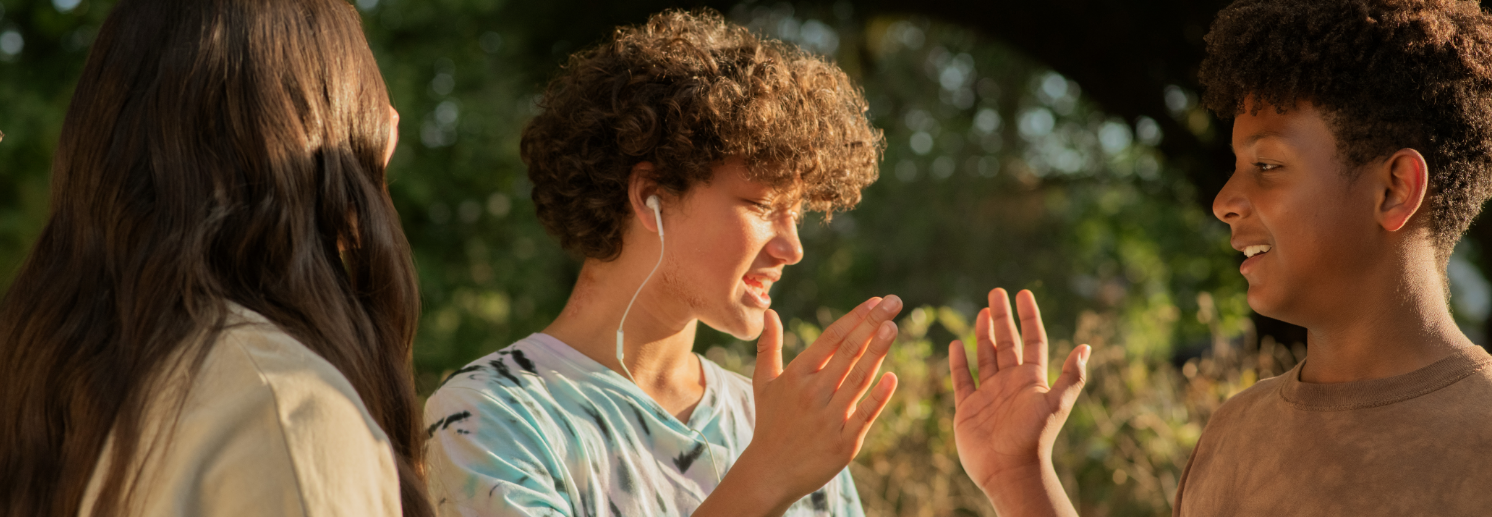 Three friends socializing and exchanging high fives